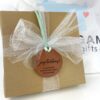 Congratulations brown leather gift tag on gift box with mint green cord and white bow