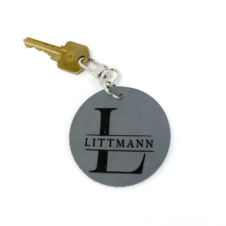 Image shows a monogrammed leather keychain that is grey. It reads "Littmann"