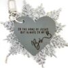Image shows a grey keychain that reads" In the arms of Jesus, but always in my heart" with a loved ones name beneath. The keychain is on a silver glittery snowflake