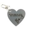 Image shows a keychain that reads "in the arms of Jesus, but always in my heart" with a name.